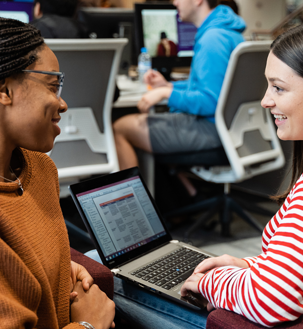 Staff talking in front of computer